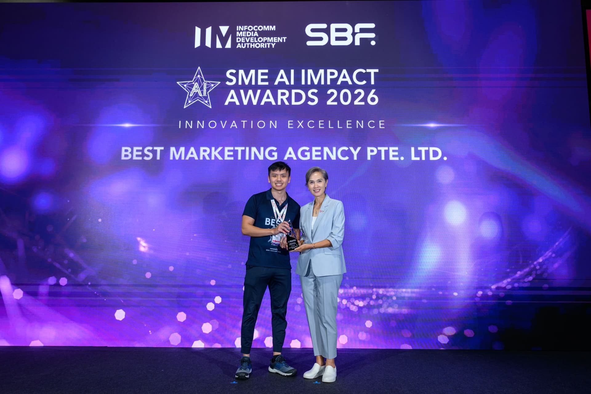 Jim Ng, founder of Best Marketing Agency, receiving the SME AI Impact Awards 2026 Innovation Excellence award from Mrs Josephine Teo, Minister for Digital Development and Information, at SMEs Go Digital Day 2026
